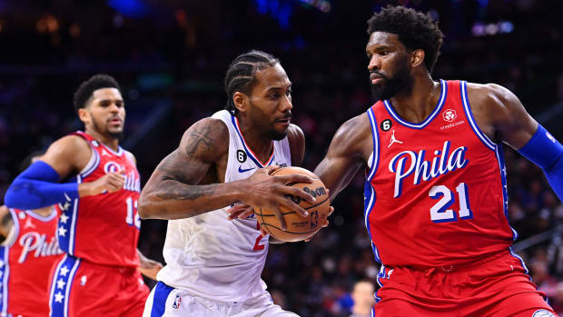 Dec 23, 2022; Philadelphia, Pennsylvania, USA; Los Angeles Clippers forward Kawhi Leonard (2) drives against Philadelphia 76ers center Joel Embiid (21) in the third quarter at Wells Fargo Center.
